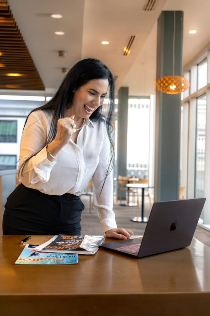 excited-businesswoman-celebrating-success-indoors-35184613